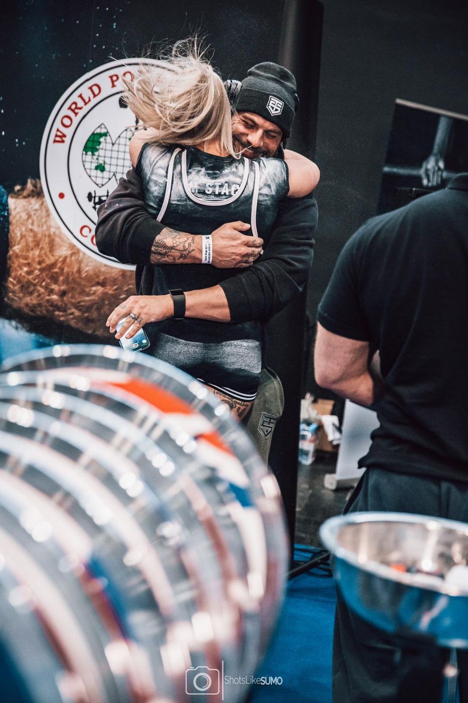 Ben hugging an athlete at a powerlifting competition